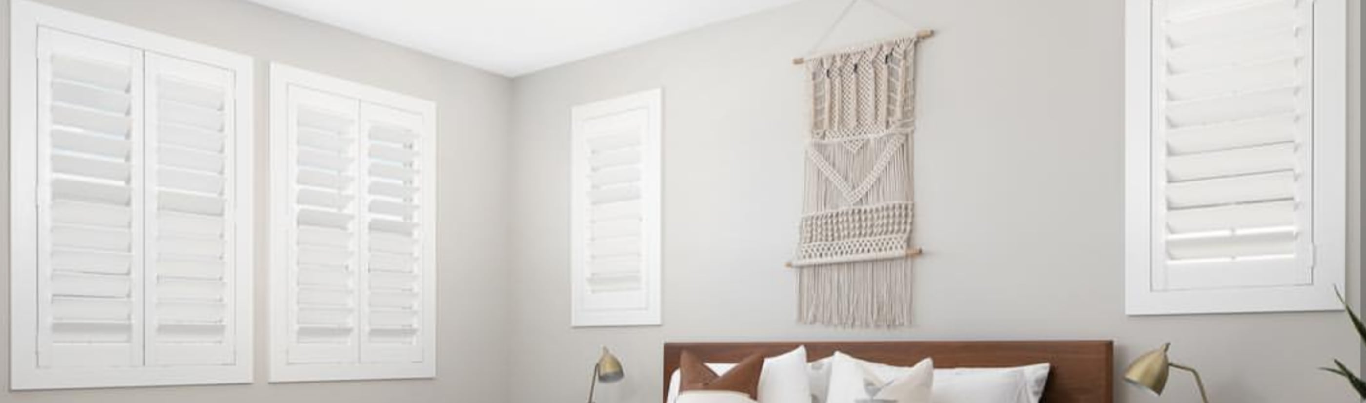 White polywood shutters in a bedroom